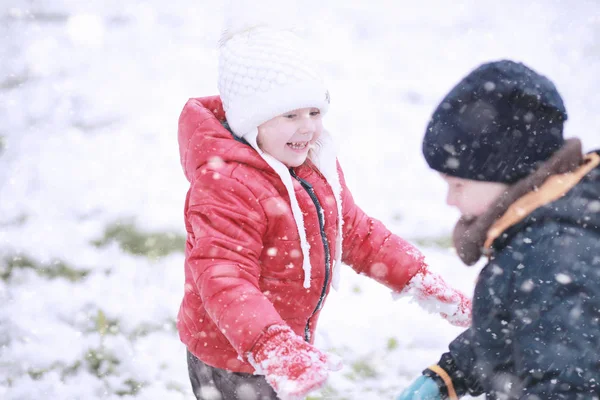 Çocuklar parkta ilk kar yürümek — Stok fotoğraf