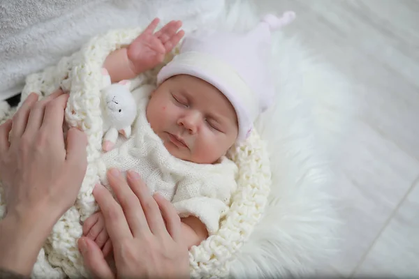 Baby newborn sleeping wrapped up in a blanket