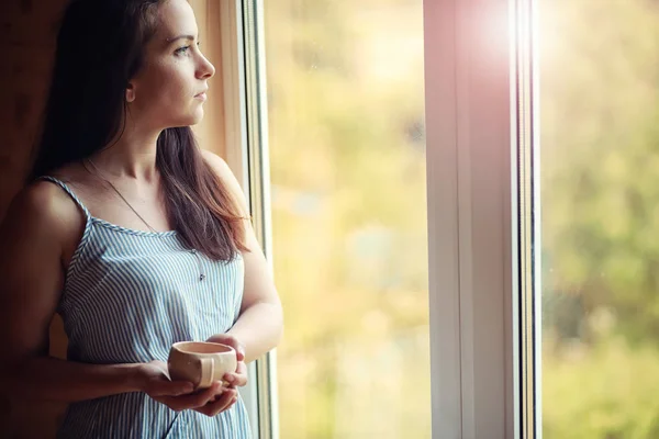 A girl at the window in the house