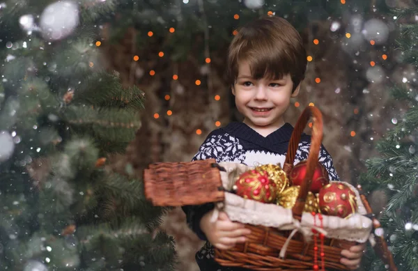 A little child by the New Year tree. Children decorate the Chris — Stock Photo, Image