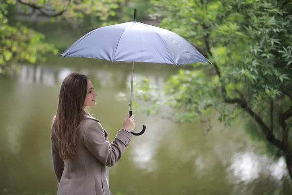 Young girl in a coat in a spring park — Stock Photo, Image