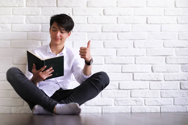 Asian young man student with books