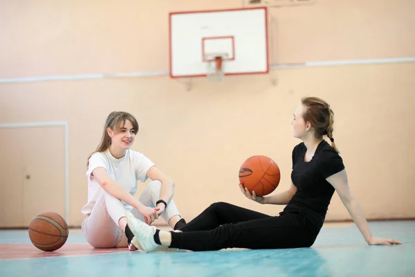 Girl in the gym playing a basketball