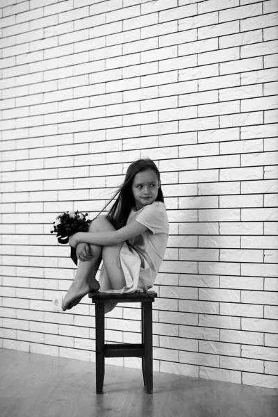 Маленька дівчинка на стільці чорно-біла — стокове фото