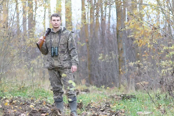 Człowiek w kamuflażu i z karabinami w pasie lasu na wiosnę hun — Zdjęcie stockowe