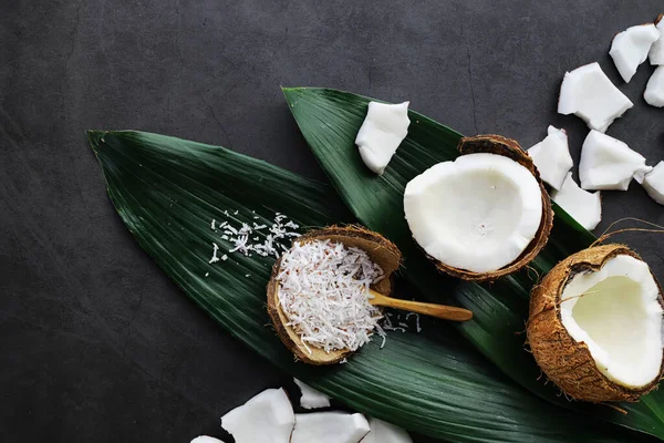 Coconut on a dark stone table. Coconut oil. — Stock Photo, Image