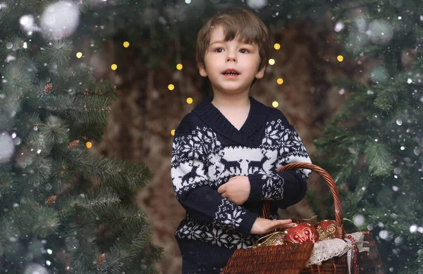 A little child by the New Year tree. Children decorate the Chris — Stock Photo, Image