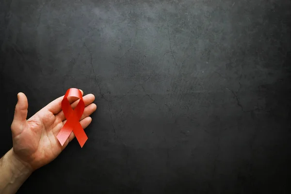 Symbol of human immunodeficiency virus disease. Red ribbon. A he