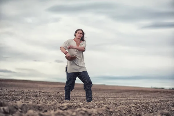 Молодий селянин сіє поле зерном — стокове фото
