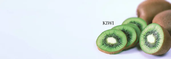 A kiwi fruit is sliced on a white background — Stock Photo, Image