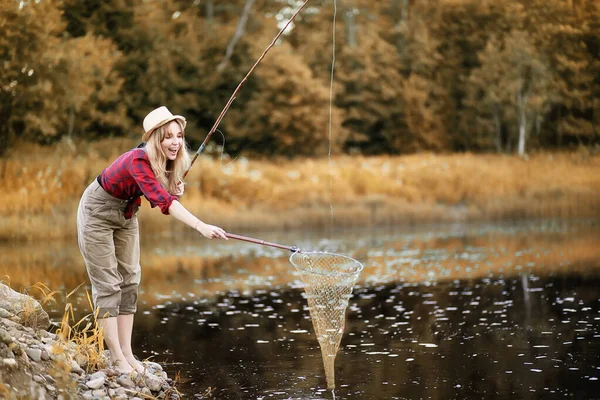 Chica en otoño con una caña de pescar —  Fotos de Stock
