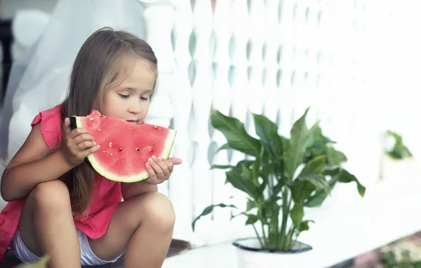 Young family eating a juicy red watermelon