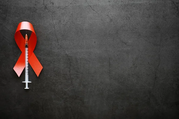 Symbol of human immunodeficiency virus disease. Red ribbon. A he
