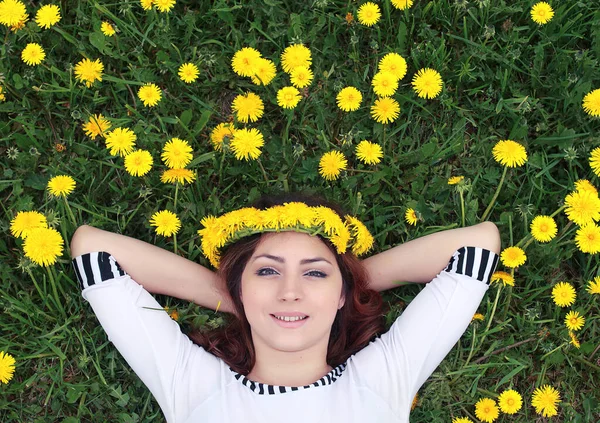 Dziewczyna na słoneczny dzień w łąka żółty mniszek lekarski — Zdjęcie stockowe