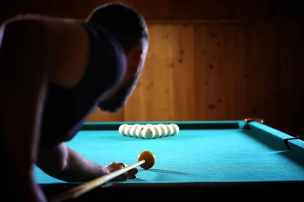 A man with a beard plays a big billiard. Party in a 12-foot pool — Stock Photo, Image