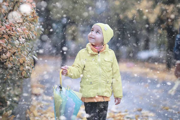 Діти гуляють в парку перший сніг — стокове фото