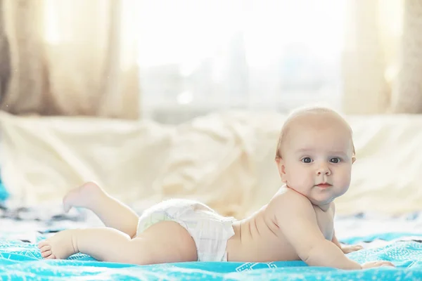A newborn baby is lying on a soft bed. — Stock Photo, Image