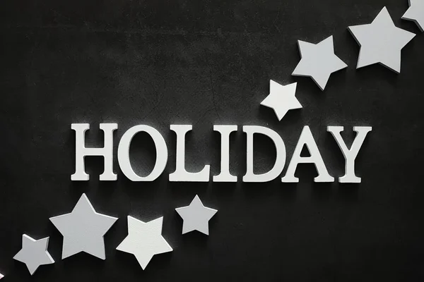 Background concept. The inscription holiday on a dark background — Stock Photo, Image