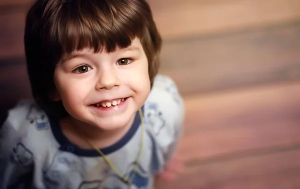 Portrait of a small curly-haired boy. A child wrapped in a rug e — Stock Photo, Image