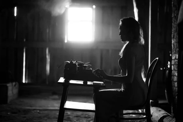 Una ragazza stampa su una vecchia macchina da scrivere — Foto Stock