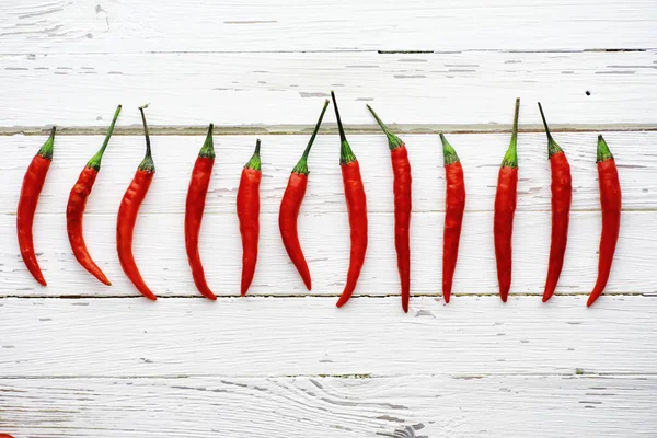 Hot red pepper on a white wooden vintage background. Stock Picture