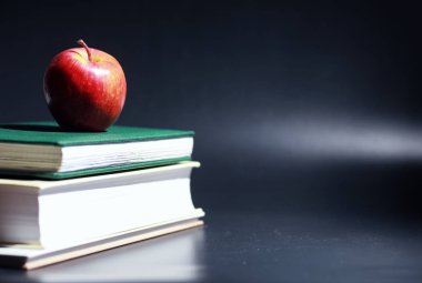 Masanın üzerinde bir yığın kitap ve ders kitabı var. Bilme konsepti