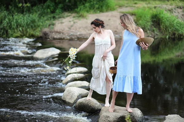 Beautiful girls in dresses on the river — Stock Photo, Image