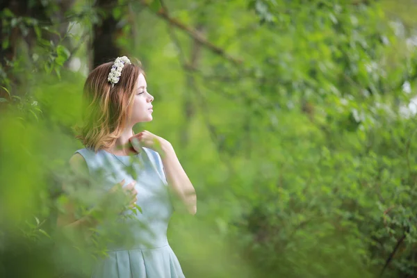 Girl in blue dress in green park — Stock Photo, Image