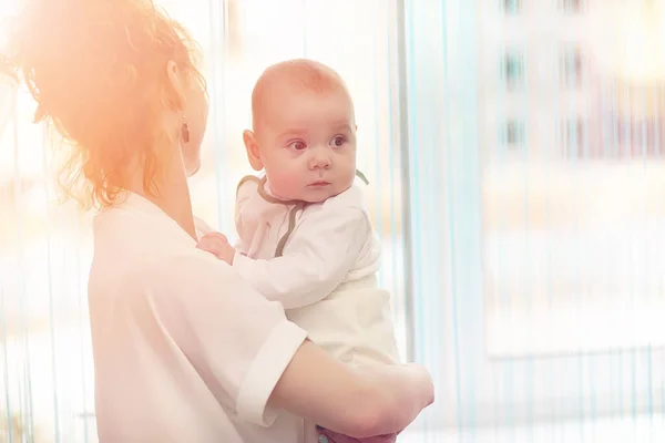 Bébé dans les bras de la fille. Maman tient son enfant dans ses bras. H — Photo