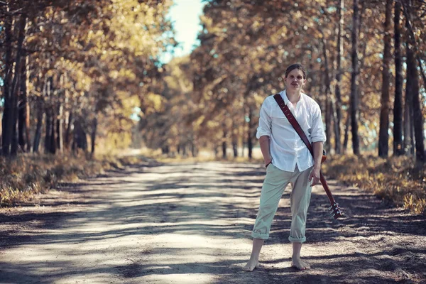 Autumn rainy weather and a young man with an umbrella — Stock Photo, Image