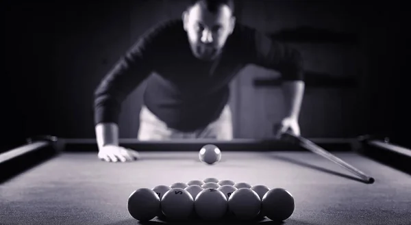 A man with a beard plays a big billiard. Party in a 12-foot pool — Stock Photo, Image