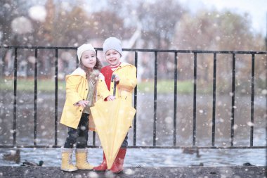 Çocuklar parkta ilk kar yürümek