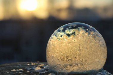 Soap bubbles freeze in the cold. Winter soapy water freezes in t clipart