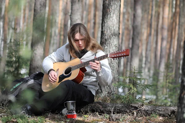 Guitarrista na floresta num piquenique. Um músico com um acústico — Fotografia de Stock