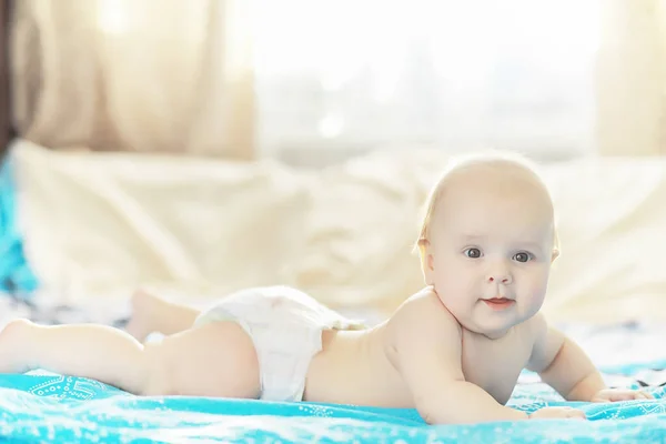 A newborn baby is lying on a soft bed. — Stock Photo, Image