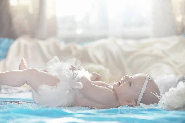 A newborn baby is lying on a soft bed. — Stock Photo, Image