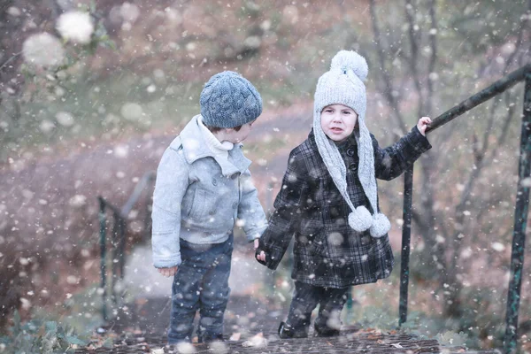 I bambini camminano nel parco prima neve — Foto Stock