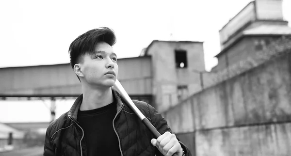 Black White photo of Asian young man outdoors posing