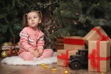 Yeni yıl Noel atmosferinde küçük bir kız. Kız happ olduğunu