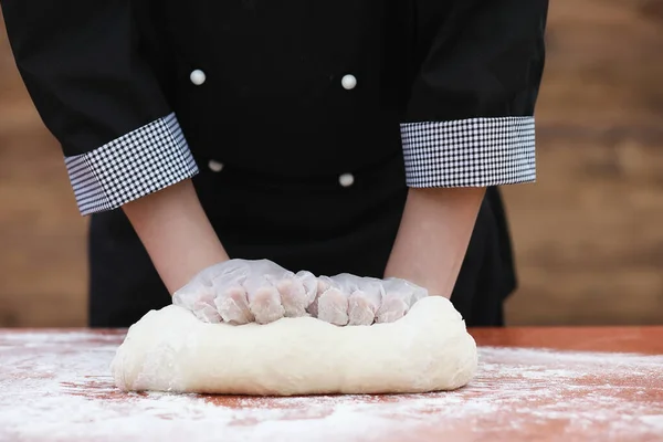 De kok maakt meel voor het bakken op tafel — Stockfoto