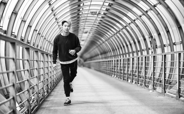 Spor giyimli bir adam açık havada tek renkli fotoğraf çalıştırın