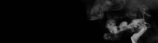 White smoke on a black background. Texture of smoke. Clubs of white smoke on a dark background for overla