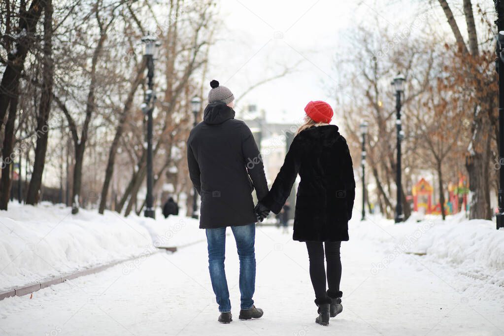 Young couple walking through the winter