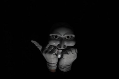 Siyah arka planda beyaz, korkunç bir maske..