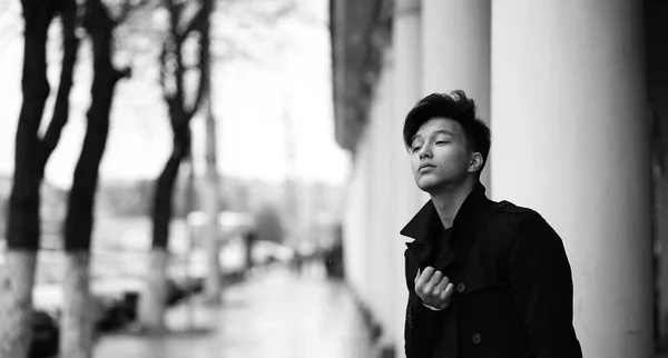 Black White photo of Asian young man outdoors posing — Stock Photo, Image