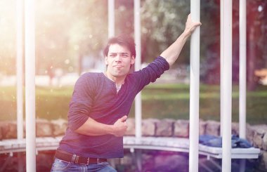 Genç bir adam öğle yemeği zamanında parkta yürür. Bir adam yürüyüşe çıktı. 