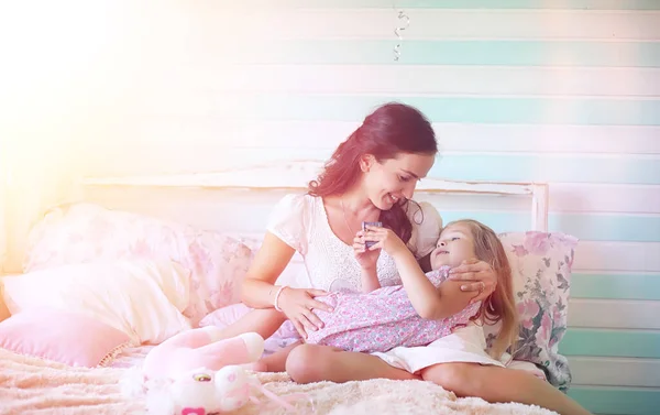 Young girl reads a book Young girl with a daughter are sitting o