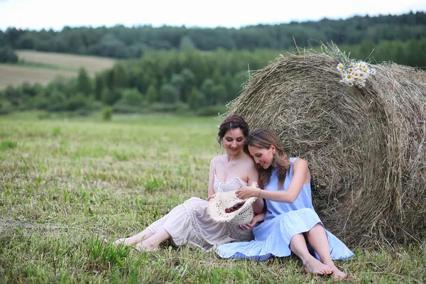 Two girls in dresses in summer field — Stock Photo, Image