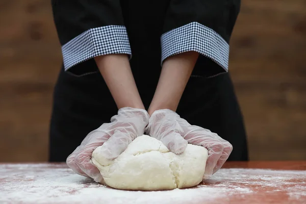 De kok maakt meel voor het bakken op tafel — Stockfoto