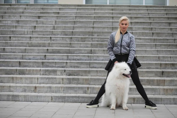 Lovely girl on a walk with a beautiful dog — Stock Photo, Image